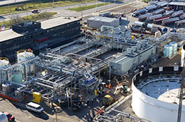 Picture of completed MBR system, installed between the engineering building on the left and a large equalization tank on the right.